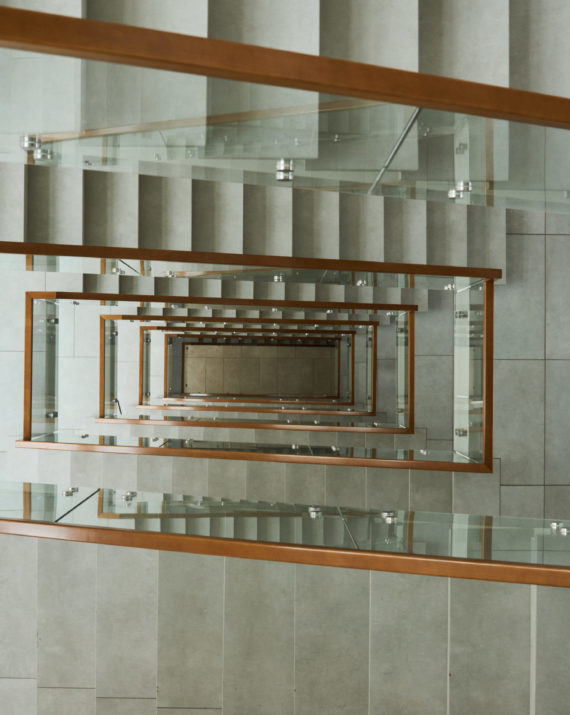 High angle view of modern stairs with glass railings in the building