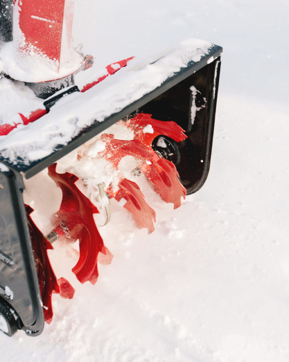 Red-black snowblower machine in the process of work. High quality photo